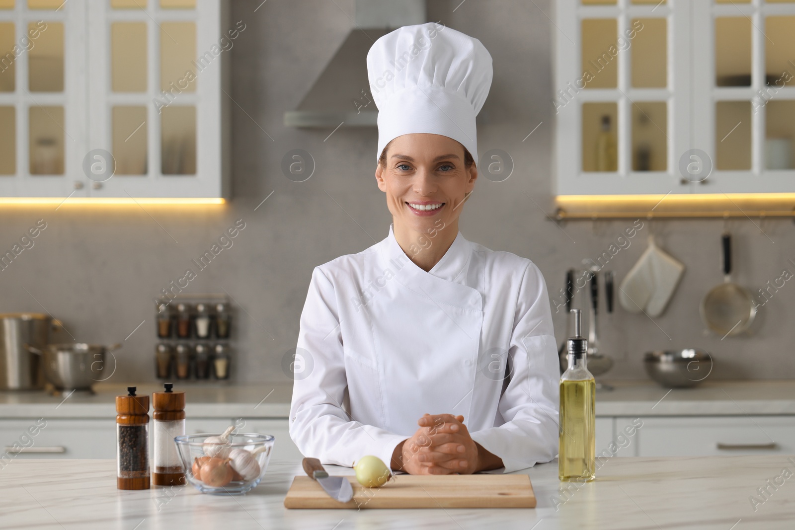 Photo of Portrait of professional chef near table with ingredients at kitchen