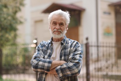 Portrait of happy grandpa with grey hair outdoors