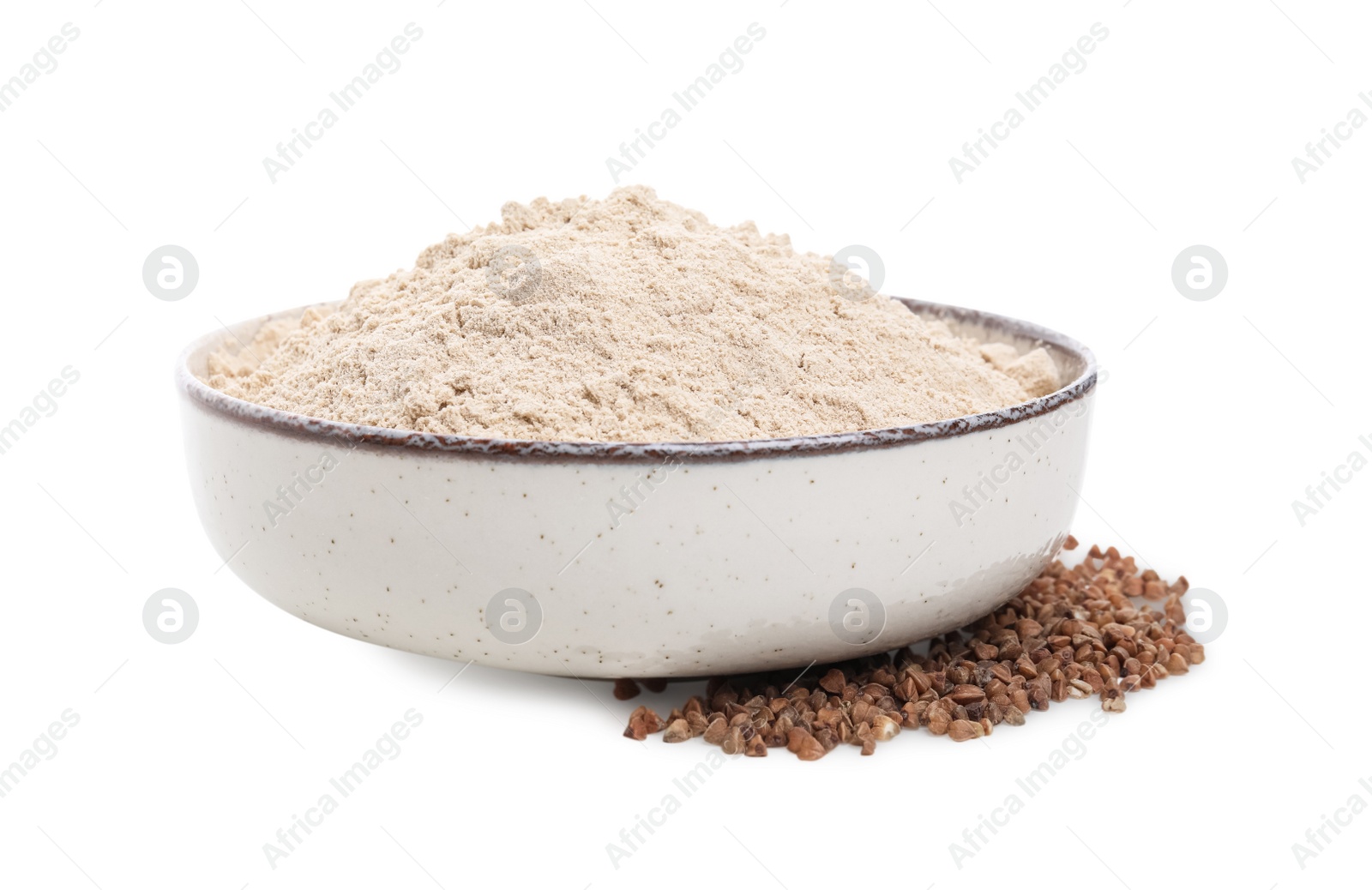 Photo of Bowl with buckwheat flour and grains on white background