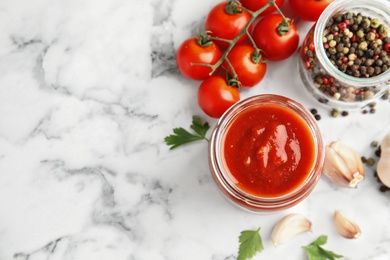 Photo of Flat lay composition with jar of tasty tomato sauce on marble table. Space for text