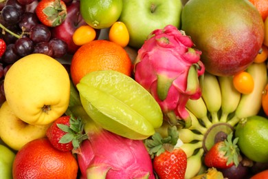 Assortment of fresh exotic fruits as background, top view