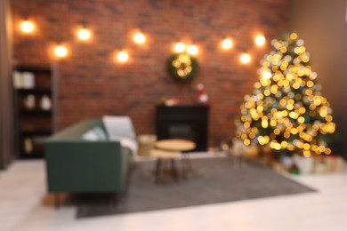 Blurred view of beautiful Christmas tree with lights in living room
