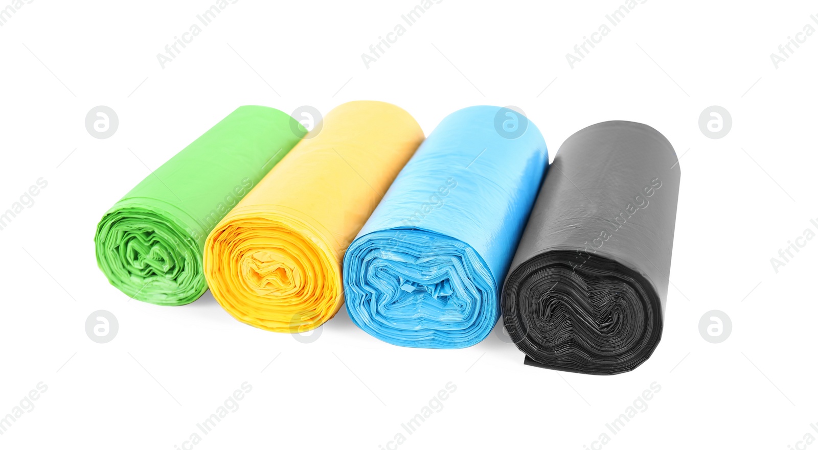 Photo of Rolls of colorful garbage bags isolated on white