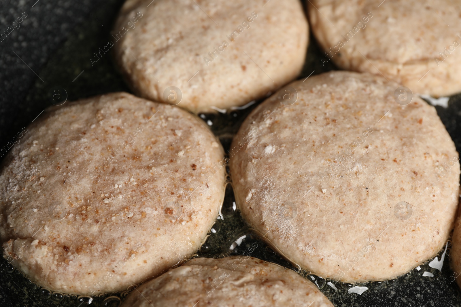 Photo of Cooking vegan nuggets in frying pan, closeup