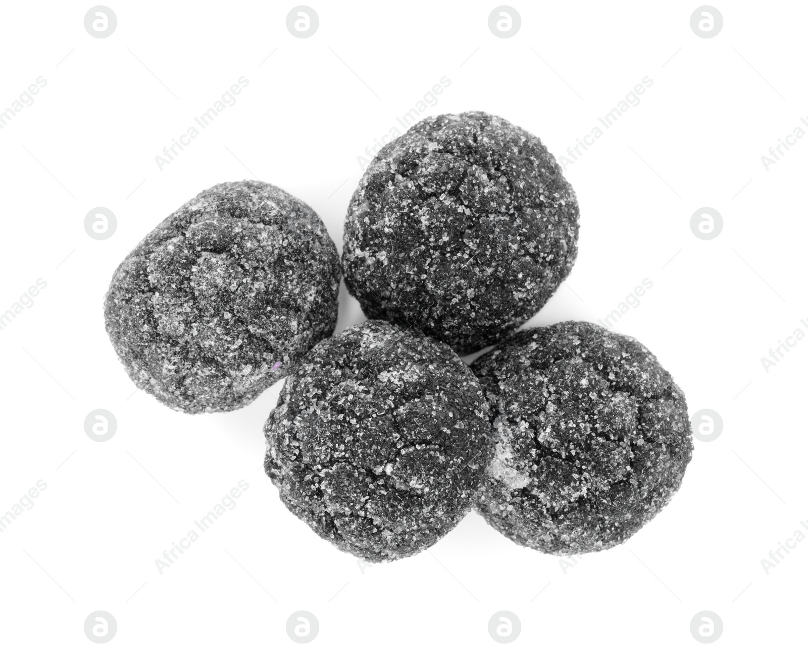 Photo of Delicious chewy candies with liquorice isolated on white, top view