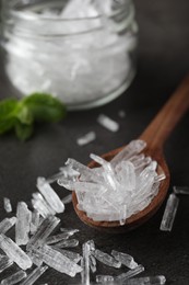 Photo of Menthol crystals in spoon on grey background, closeup