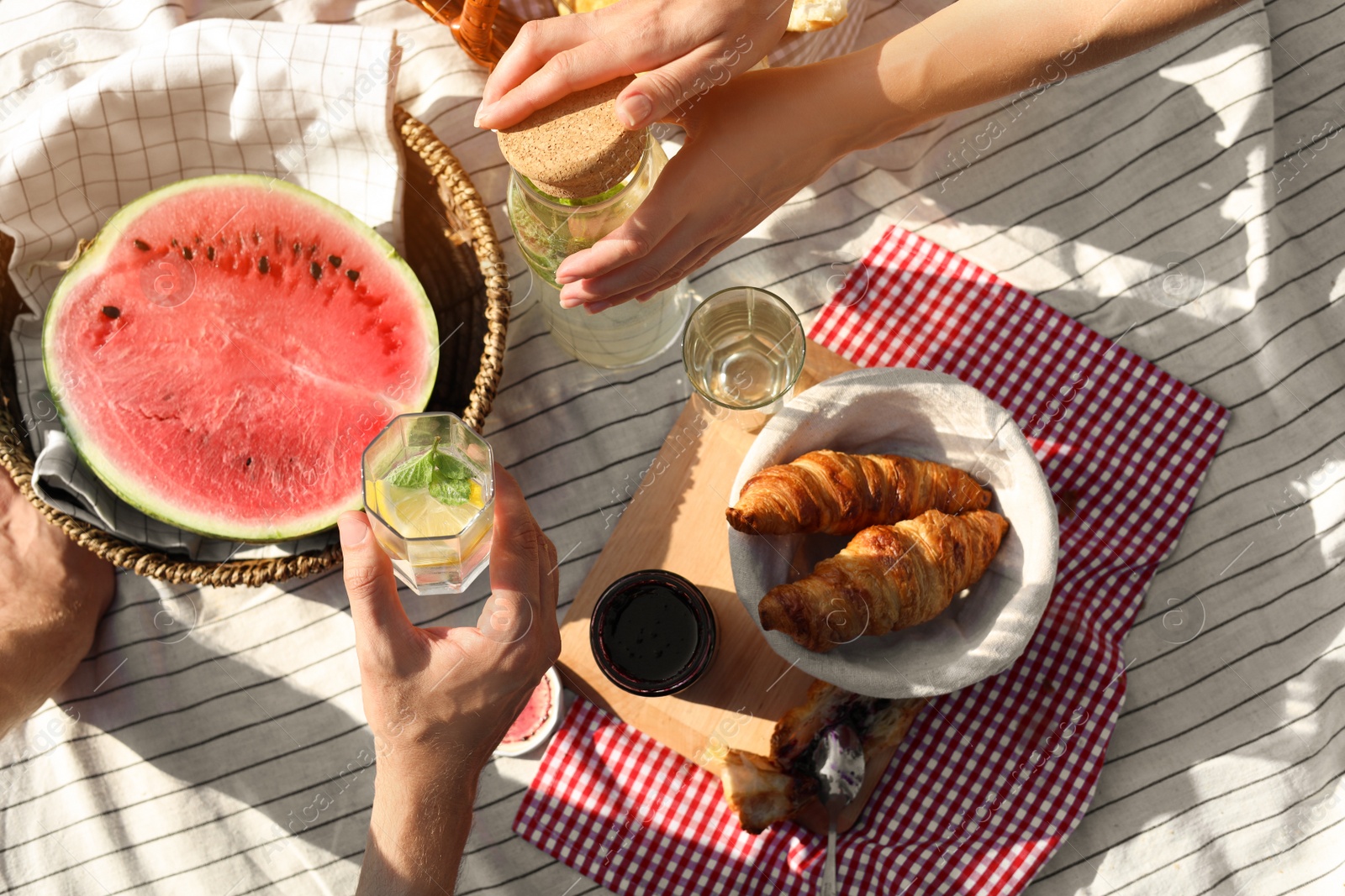 Photo of Lovely couple having picnic on sunny day, top view