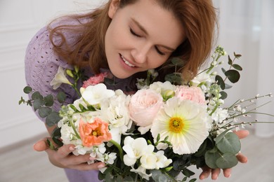 Photo of Beautiful woman with bouquet of flowers indoors