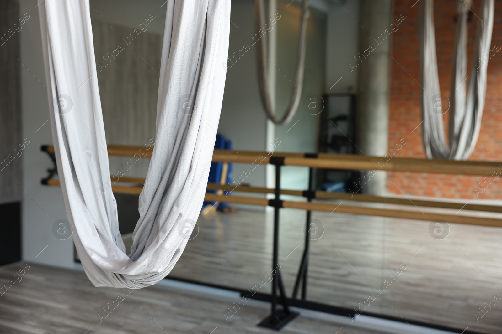 Photo of Many hammocks for fly yoga in studio, space for text