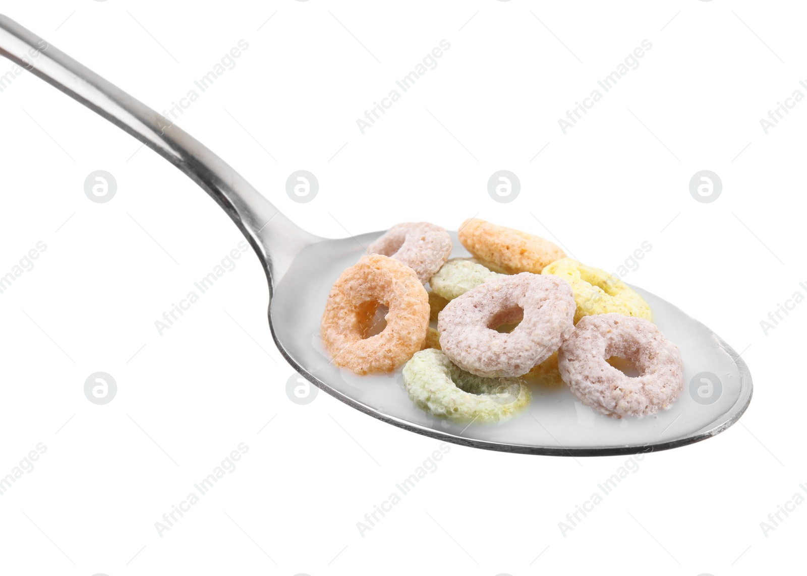 Photo of Cereal rings and milk in spoon isolated on white