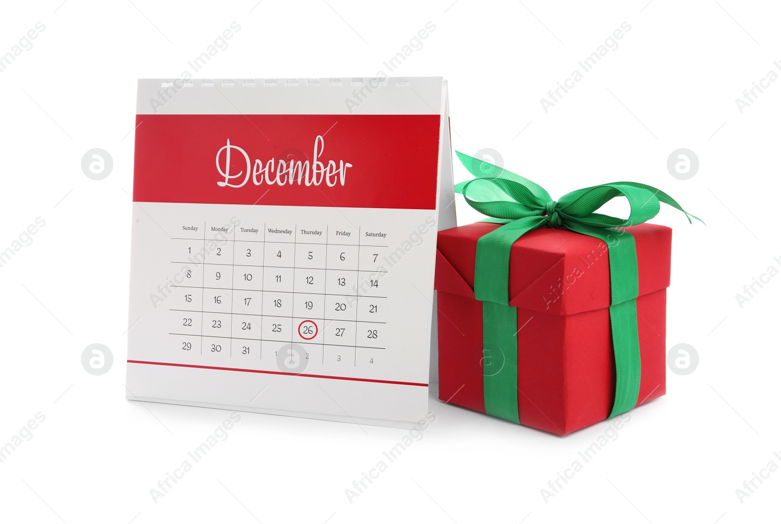 Photo of Calendar with marked Boxing Day date and gift on white background