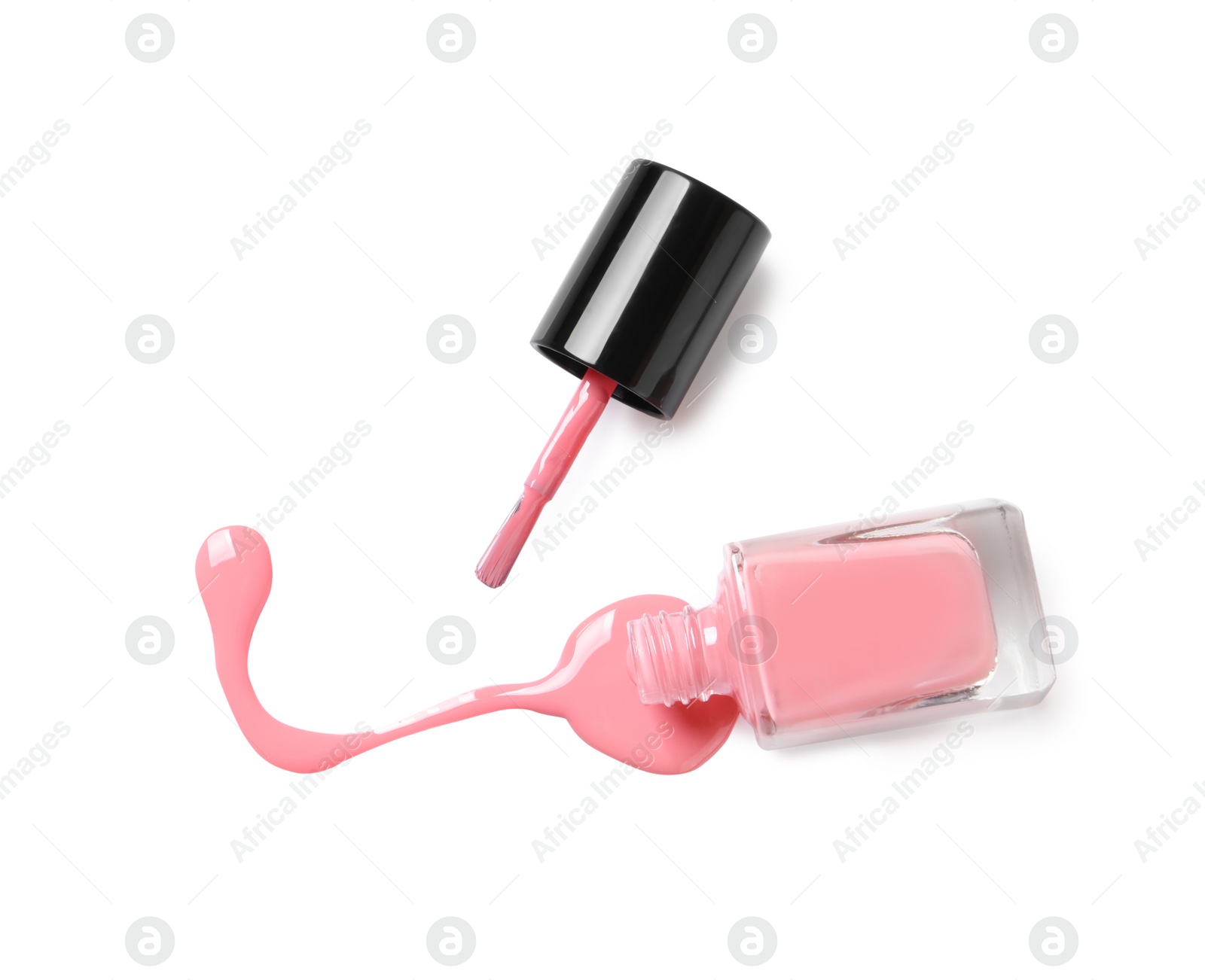 Photo of Spilled color nail polish with bottle and brush on white background, top view