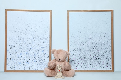 Photo of Soft toys and pictures on white background. Child room interior decor
