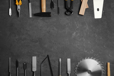 Flat lay composition with carpenter's tools on grey background. Space for text