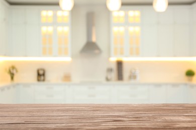 Empty wooden table and blurred view of stylish kitchen interior. Mockup for design