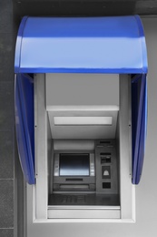 Photo of Modern color automated teller cash machine outdoors