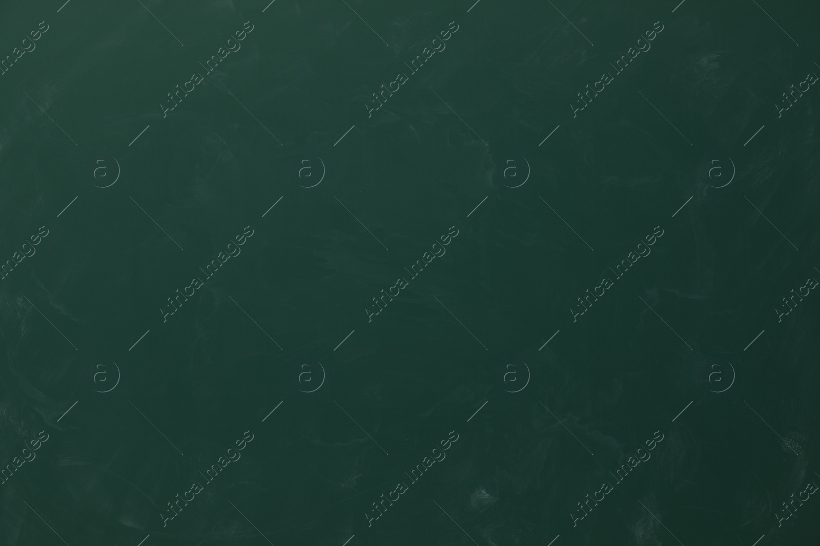 Photo of Dirty green chalkboard as background. School equipment