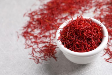 Photo of Dried saffron on grey table, closeup. Space for text