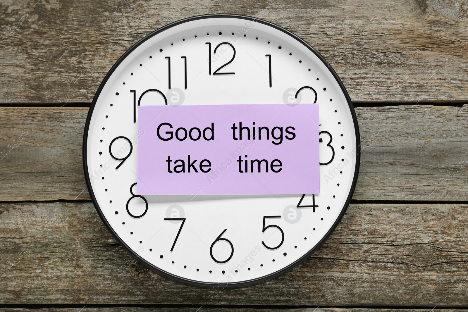 Photo of Phrase Good Things Take Time and clock on wooden table, top view. Motivational quote