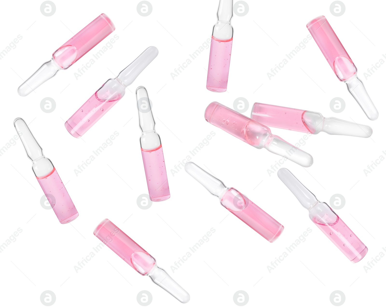 Image of Many glass ampoules with pharmaceutical products falling on white background