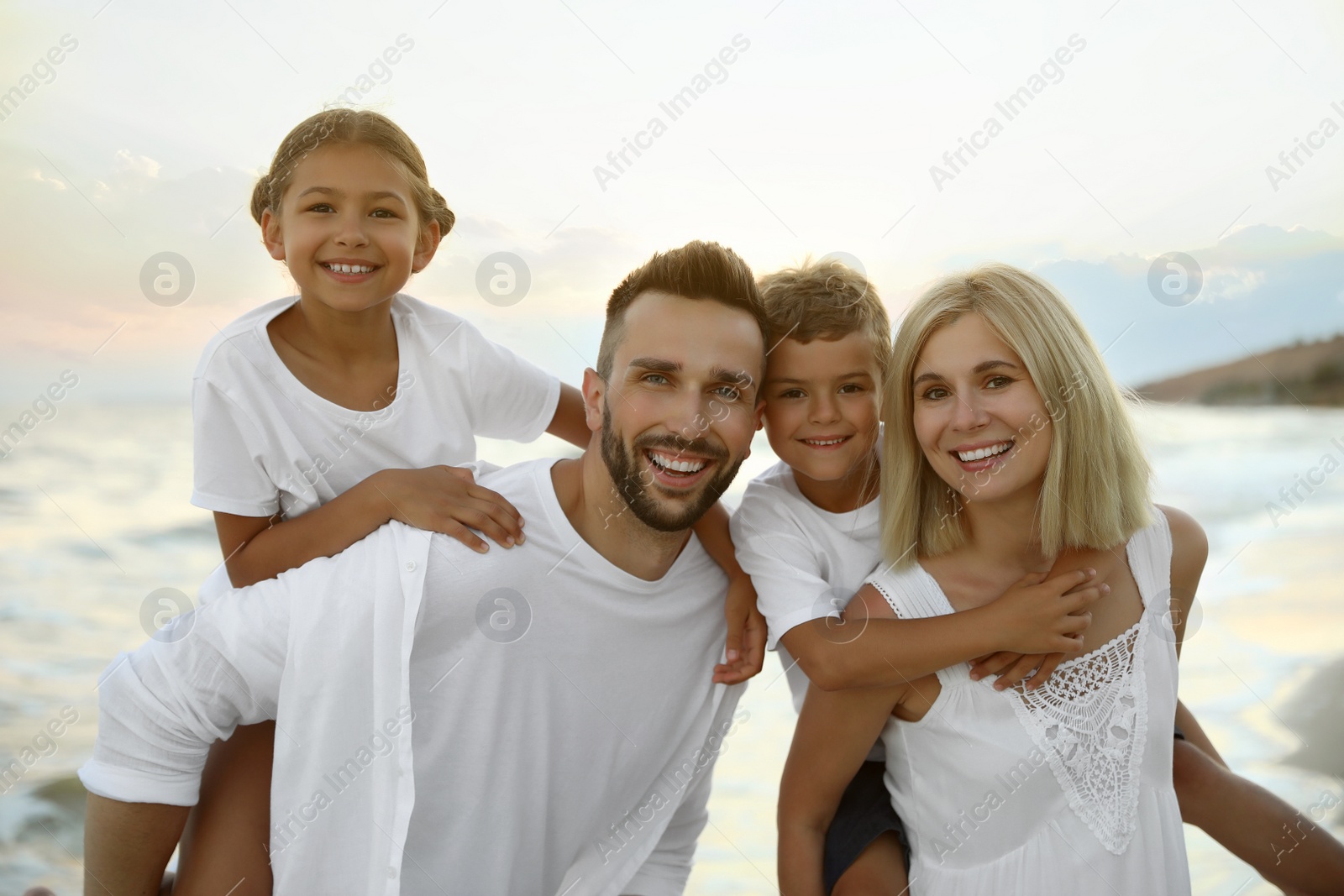 Photo of Happy family on beach near sea. Summer vacation