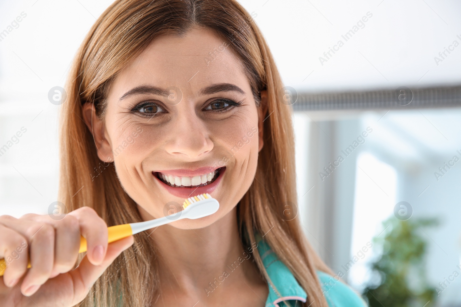 Photo of Portrait of woman with toothbrush in bathroom. Personal hygiene