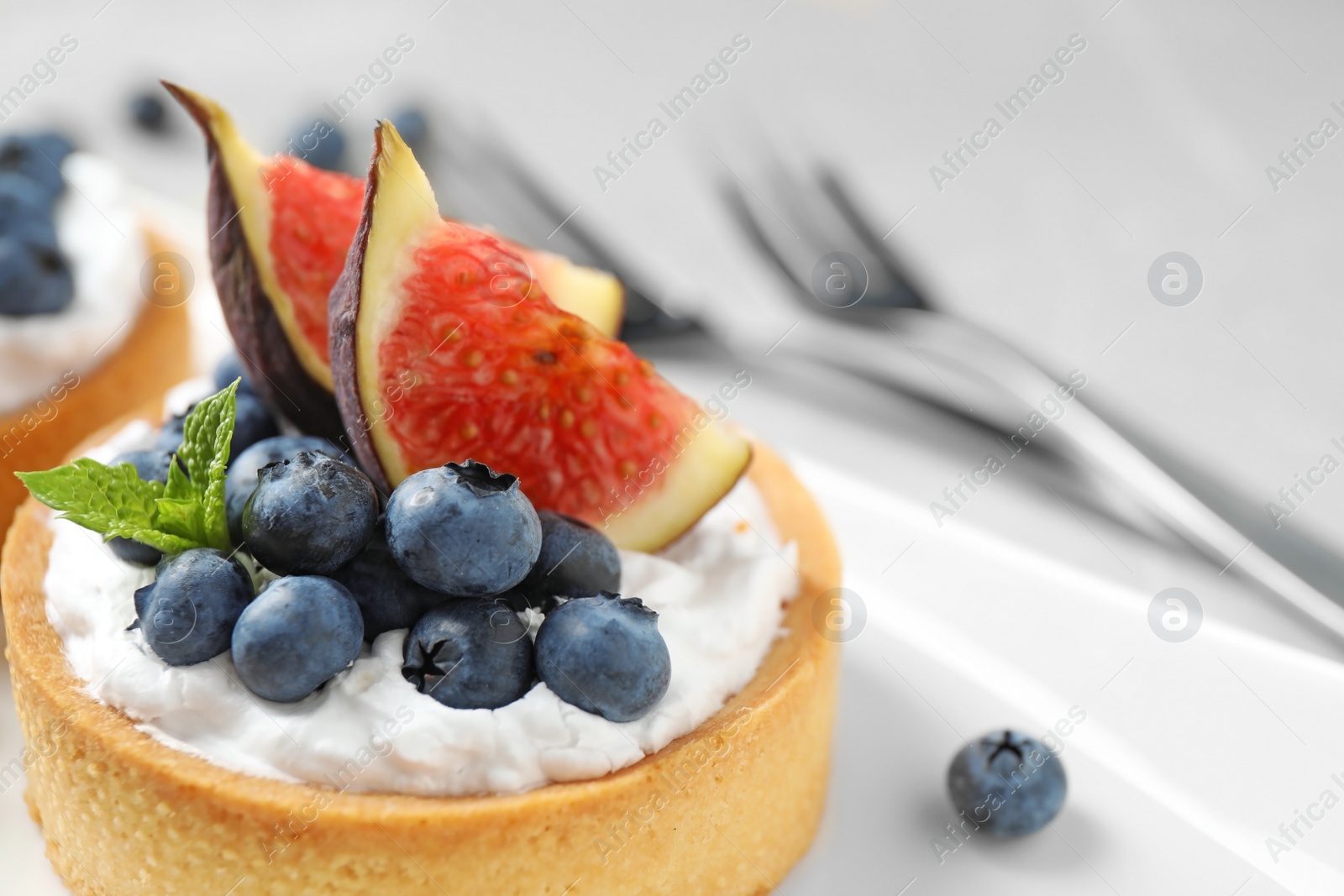 Photo of Tart with blueberries and figs, closeup. Delicious pastries