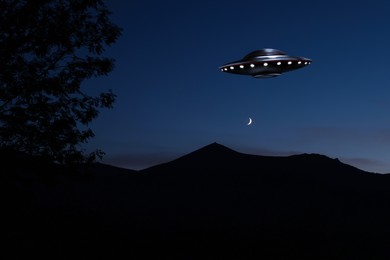 Image of UFO. Alien spaceship over mountains in sky. Extraterrestrial visitors