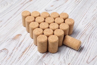 Photo of Christmas tree made of wine corks on white wooden table, above view