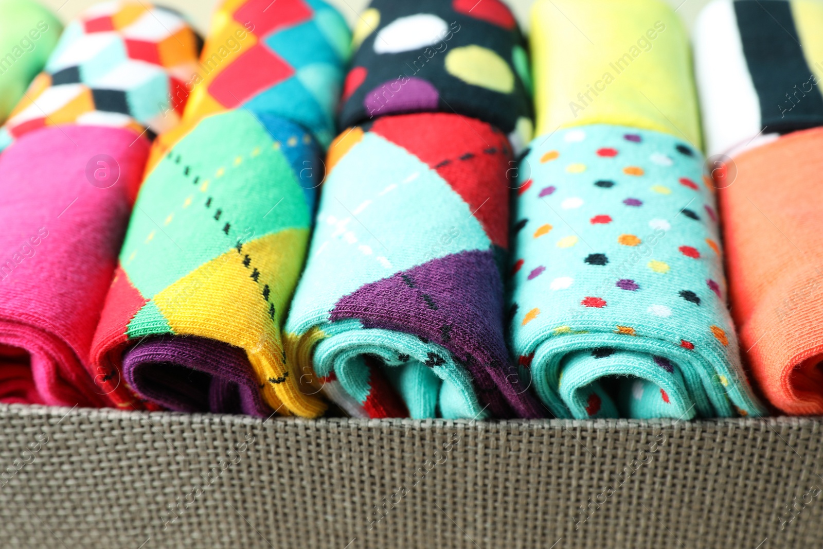 Photo of Box with different colorful socks, closeup