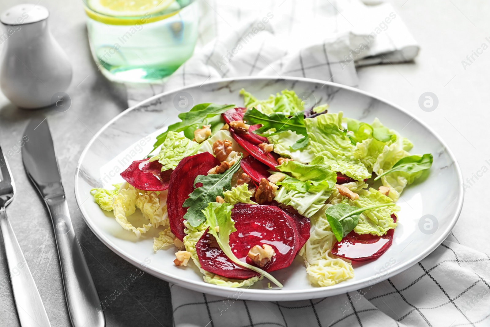 Photo of Plate with delicious beet salad served on table