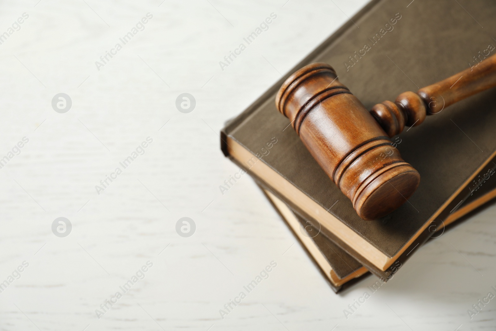 Photo of Wooden gavel and books on light table. Law concept