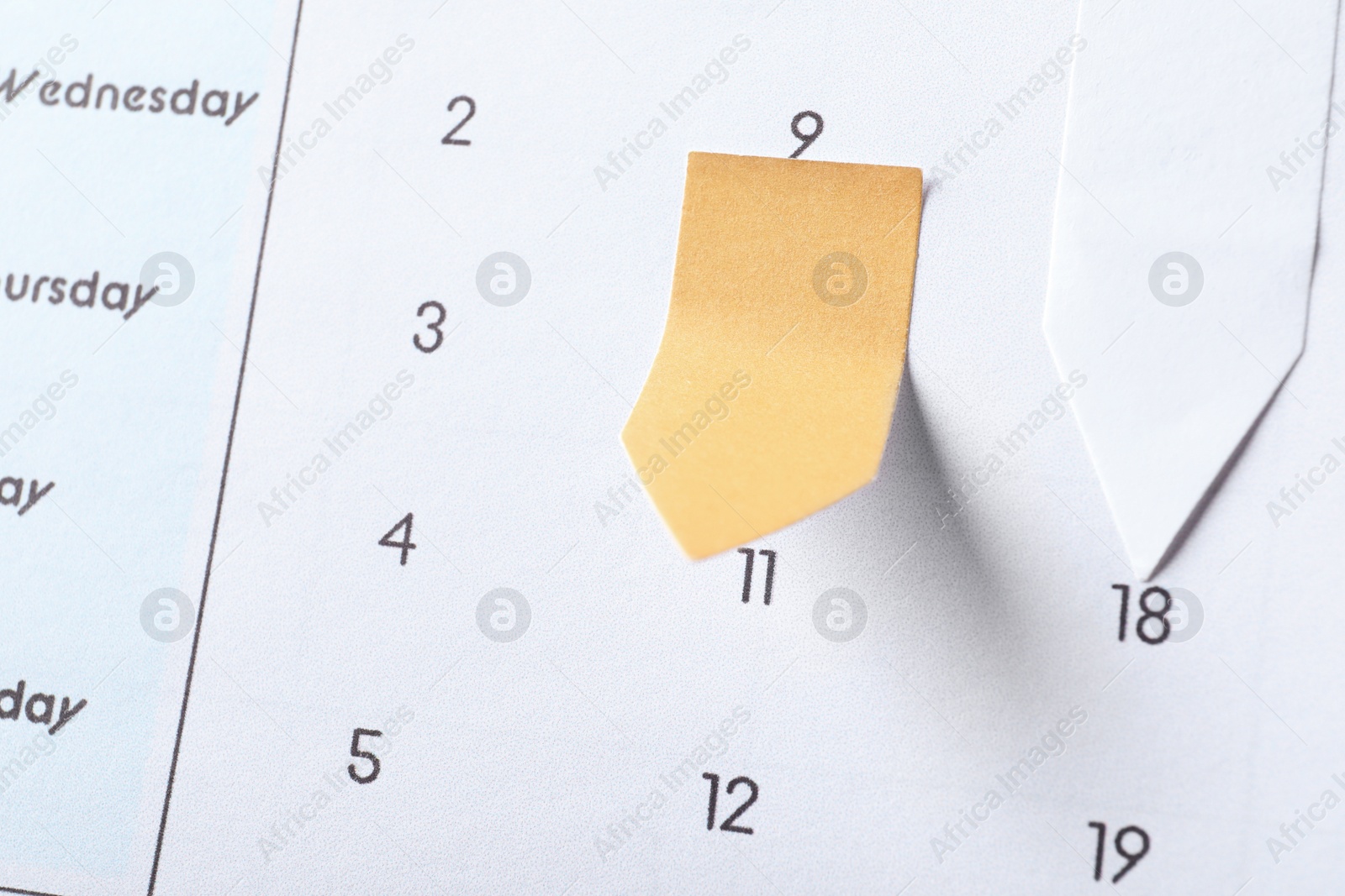 Photo of Calendar page with paper stickers, closeup view