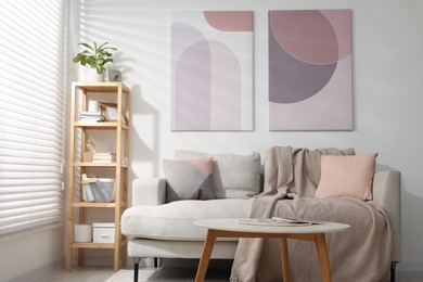 Stylish living room interior with sofa, coffee table and wooden shelf