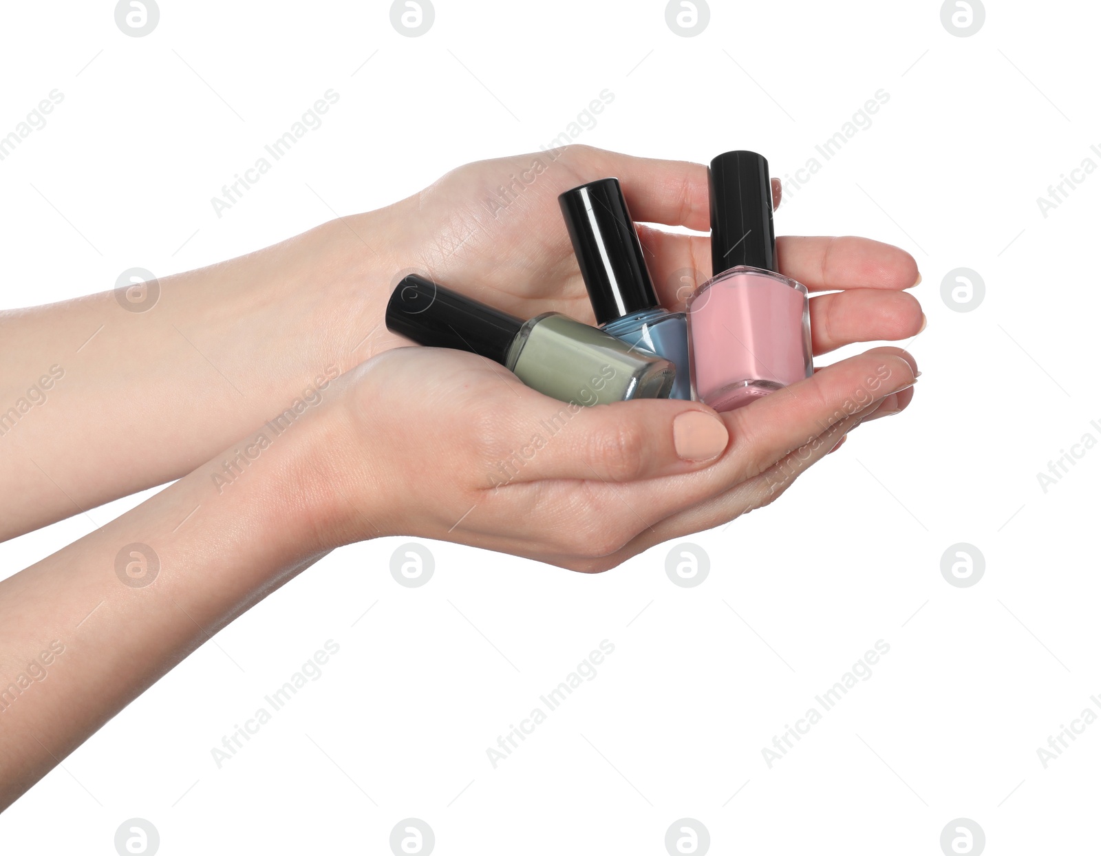 Photo of Woman holding nail polishes on white background, closeup