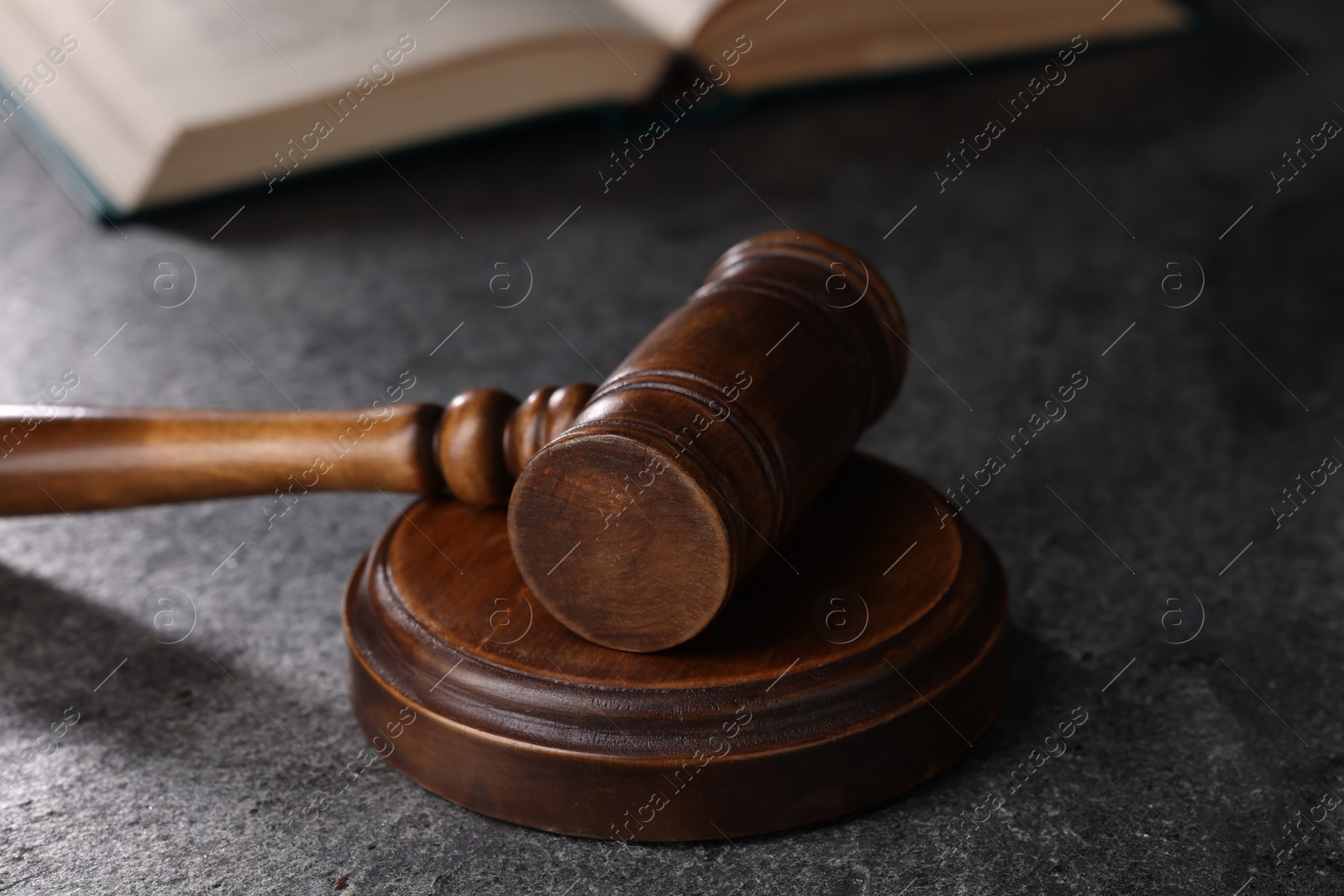 Photo of Law concept. Judge's gavel on grey textured table, closeup