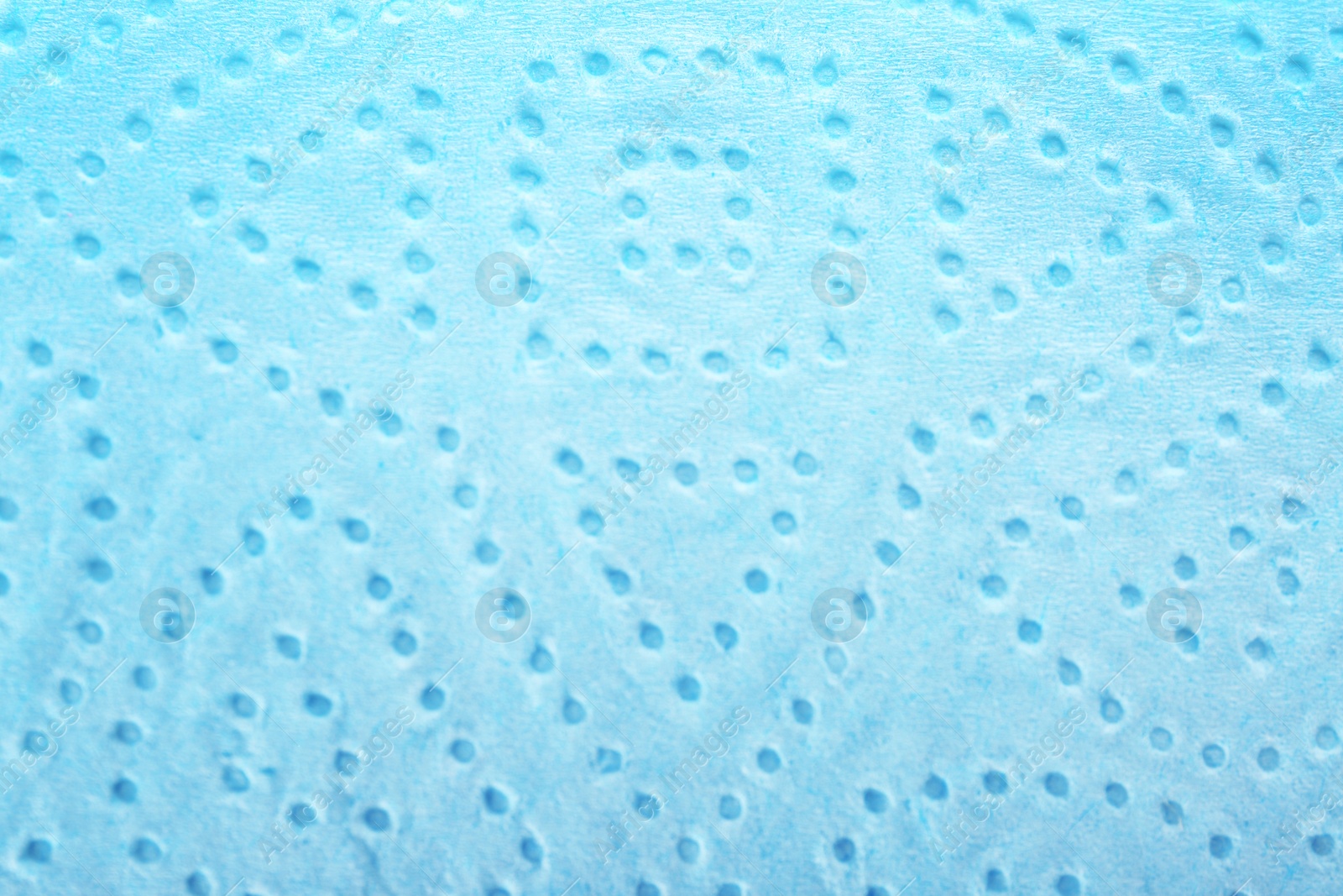 Photo of Perforated toilet paper as background, closeup. Personal hygiene