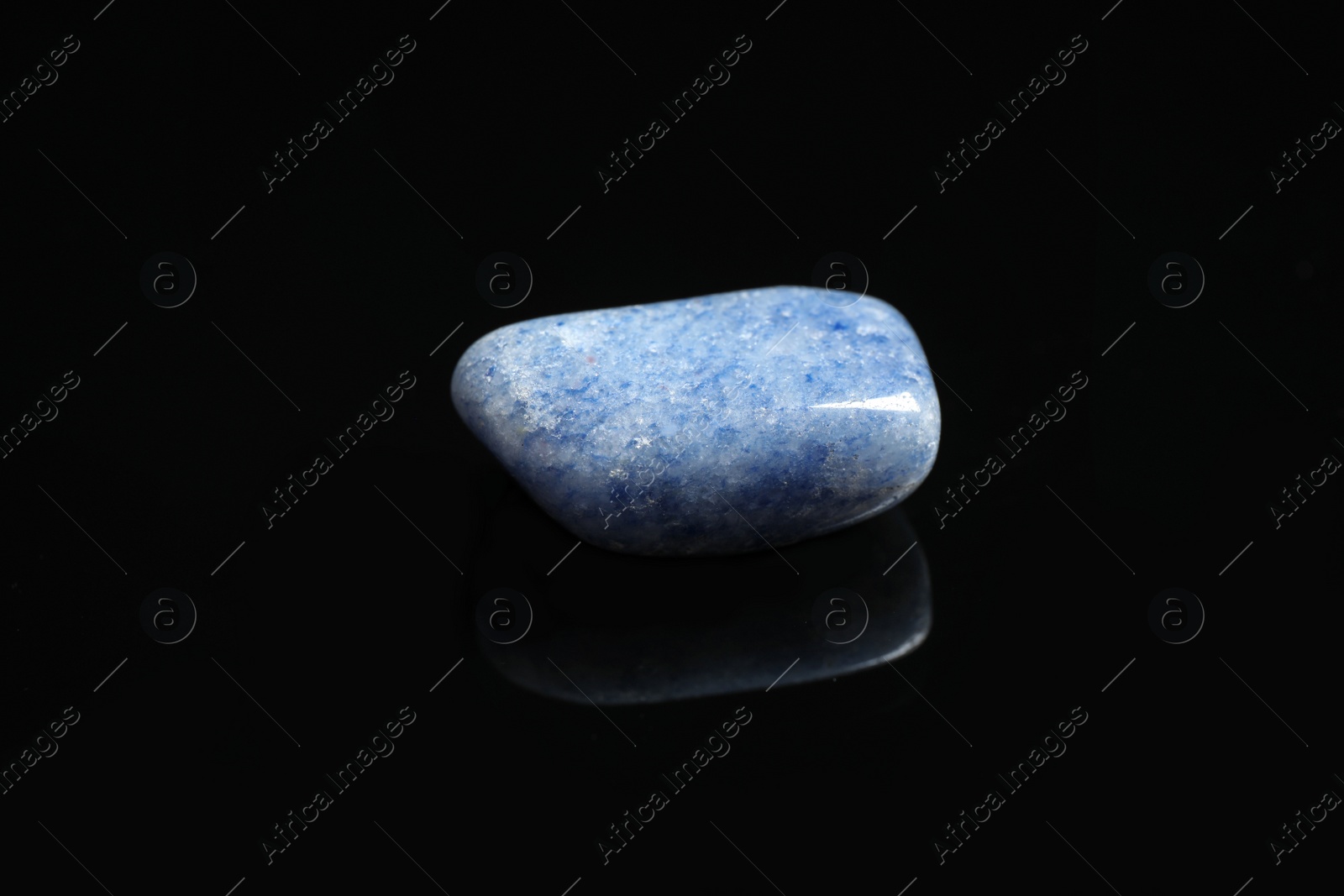 Photo of Beautiful blue quartz gemstone on black background