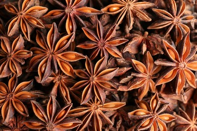 Photo of Aromatic anise stars as background, top view