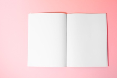 Photo of Empty book pages on pink background, top view. Mockup for design