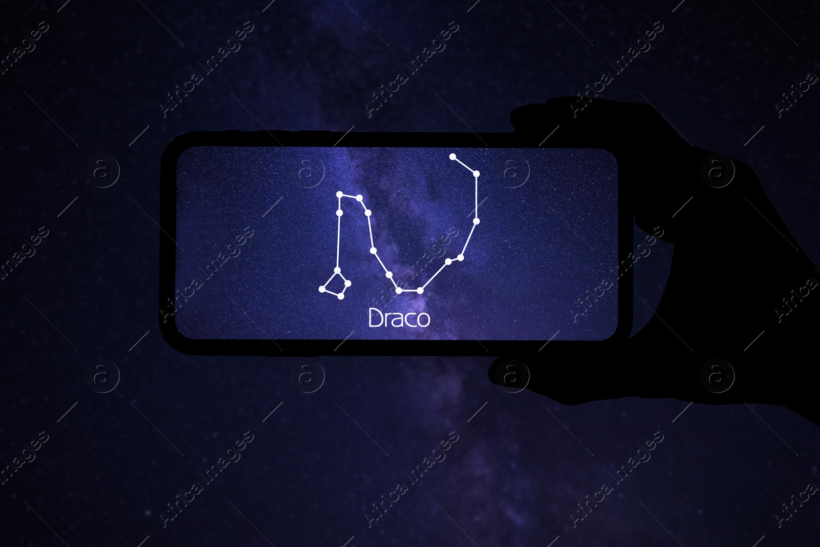 Image of Woman using stargazing app on her phone at night, closeup. Identified stick figure pattern of Dragon (Draco) constellation on device screen