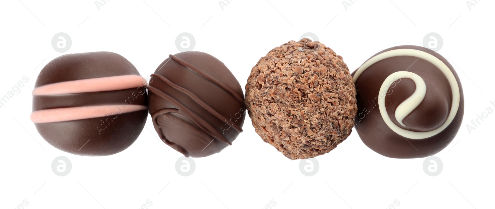 Photo of Many different delicious chocolate truffles on white background, top view