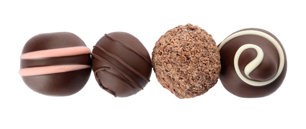 Photo of Many different delicious chocolate truffles on white background, top view