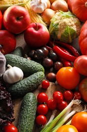 Different fresh ripe vegetables and fruits on wooden table, above view