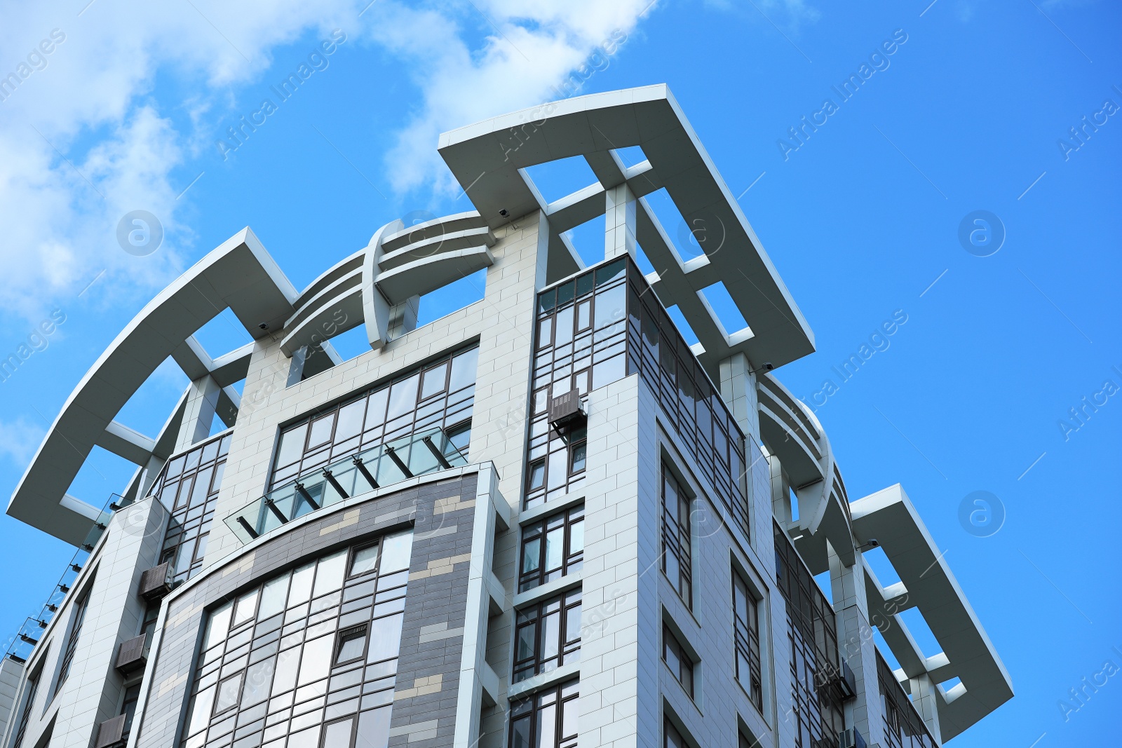 Photo of Low angle view of modern building against blue sky