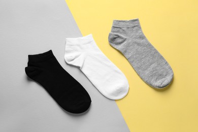 Photo of Different socks on colorful background, flat lay