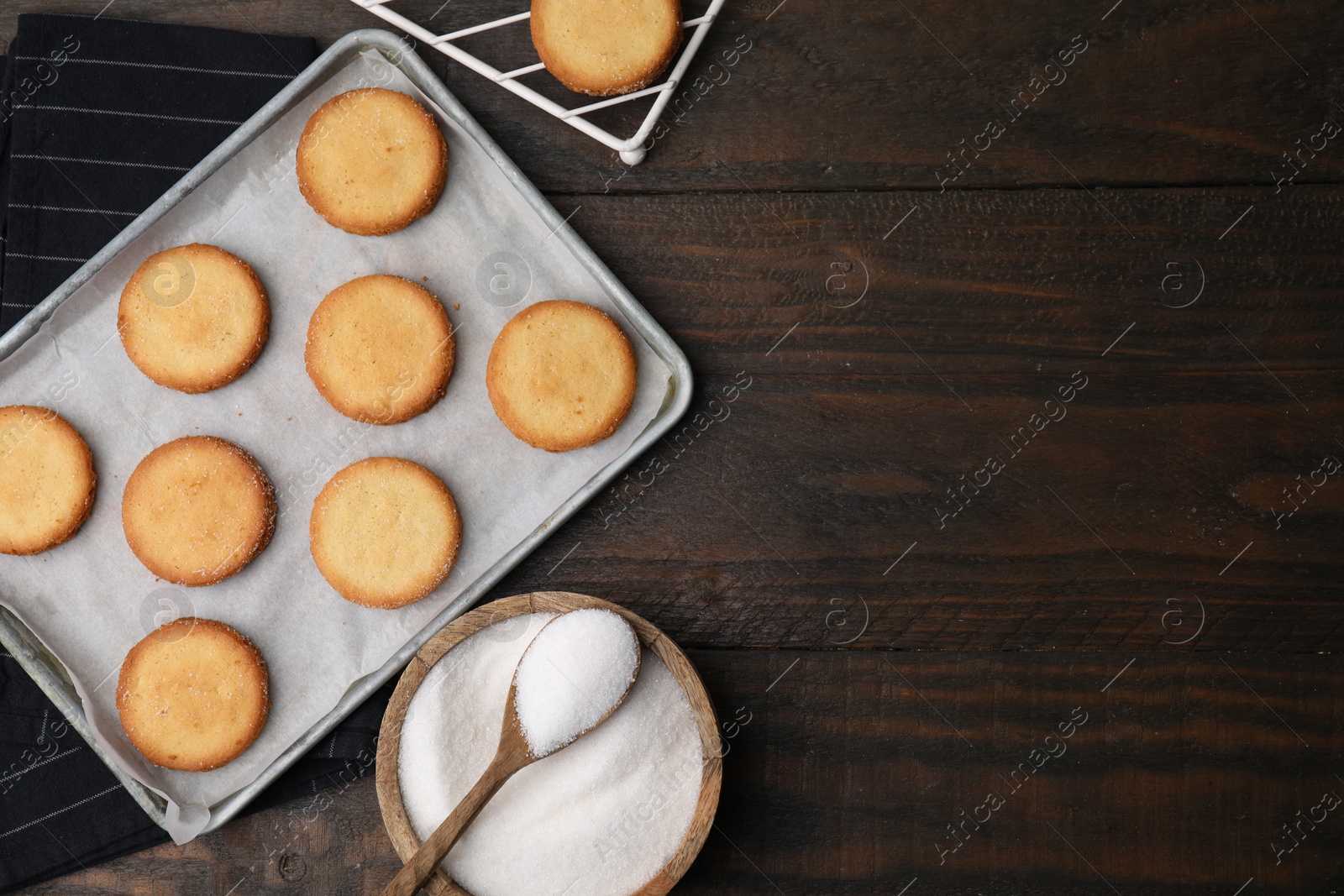 Photo of Tasty sweet sugar cookies on wooden table, flat lay. Space for text