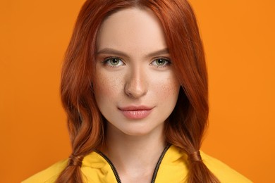 Photo of Portrait of beautiful woman on orange background