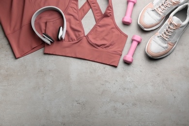 Photo of Flat lay composition with sportswear and equipment on grey table, space for text. Gym workout
