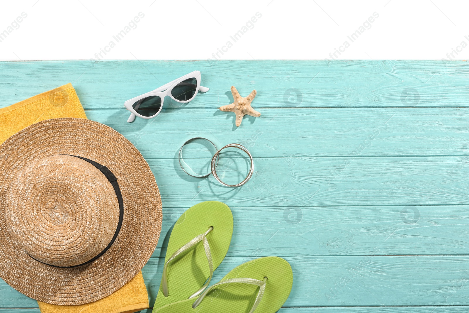 Photo of Flat lay composition with beach accessories on wooden background. Space for text